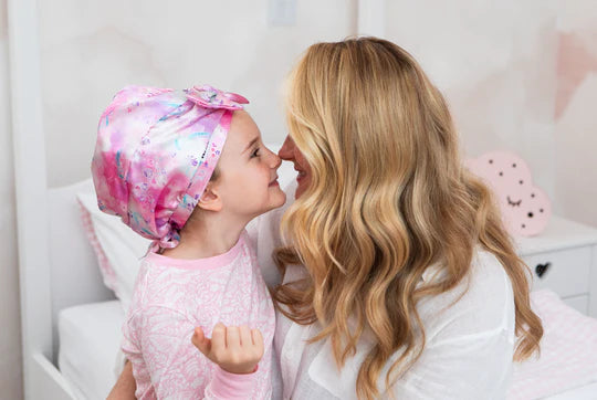 Mother and Daughter together nose rubbing, child wearing Kidsilk hair wrap